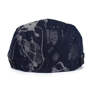 Detail of navy printed cotton beret featuring vintage floral patterns and metal side buckle