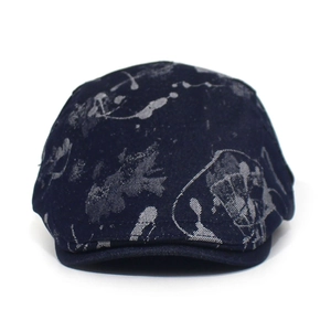 Close-up of a navy cotton flat cap with artistic grey abstract patterns on a white background