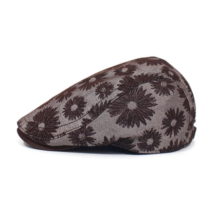 Detail view of cotton flat cap featuring vintage brown fabric with daisy floral prints