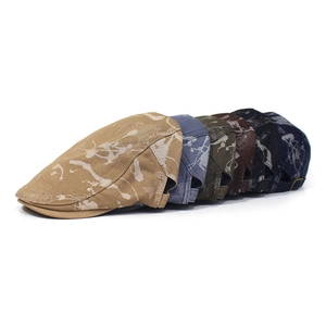 Detail view of cotton flat caps with vintage splash ink pattern and metal buckles