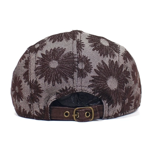 Detail of floral daisy beret with adjustable antique bronze buckle and cotton fabric