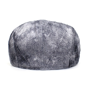 Detail view of the back of a vintage grey flat cap with leaf vein textured stitching patterns