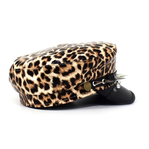 Detail view of leopard print baker boy hat with silver metal spikes on a leather band