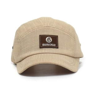 Detail van beige 5-panel camperpet met merkpatch en duurzame ripstop-textuur van de stof
