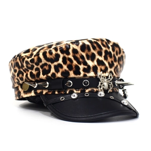 Detail of silver spider charm and punk metal rivets on the leopard print military hat