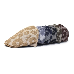 Detail view of cotton flower print beret hats showing textured daisy patterns in six colors