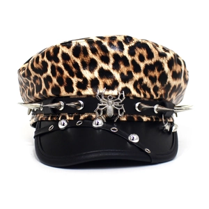 Detail of leopard print punk cap featuring metal spider logo and sharp silver studs