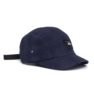 Detail of navy blue five-panel camper hat featuring metal eyelets and adjustable strap