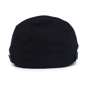 Detail of black cotton flat top cap showing metal adjustable buckle and stitching