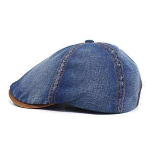 Detailed side view of washed denim octagonal hat with contrast stitching and leather brim
