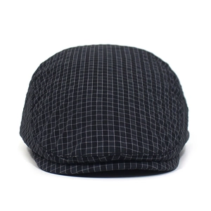 Close-up of quick-dry plaid flat cap featuring detailed woven check pattern and stitch