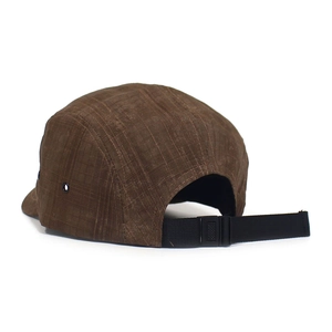 Detail of brown camp hat with grid texture, metal eyelets and adjustable buckle strap