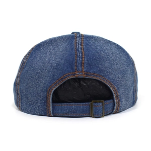 Adjustable back strap of blue washed denim newsboy cap with bronze metal buckle