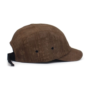 Detail of vintage brown 5-panel camp cap with metal side eyelets and adjustable buckle