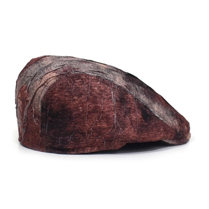 Detailed view of vintage beret cap with distressed reddish-brown wrinkled texture and brim