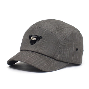 Gray grid pattern baseball cap with metal letter patch and adjustable strap closure