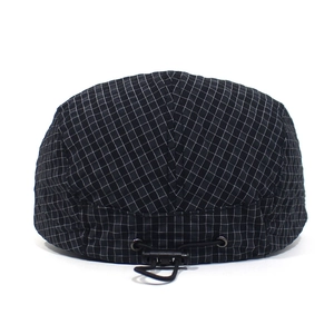 Detail view of adjustable elastic drawstring and plastic fastener on black mesh beret hat