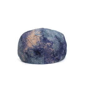 Close-up of the vintage marble texture and veined pattern on this navy blue flat cap
