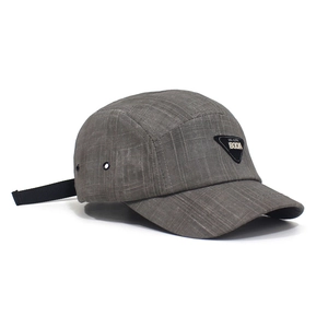 Detail of grey baseball cap with metal eyelet and adjustable nylon strap closure