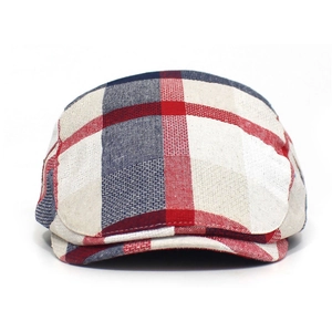 Detail of red and blue tartan plaid fabric texture on a classic cotton flat cap