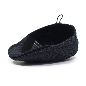 Detail of checkered flat cap with elastic band adjustment and soft black inner lining