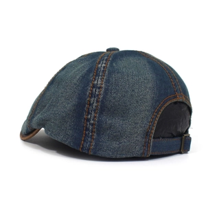 Detail of washed denim cap showing contrast stitching and adjustable metal buckle