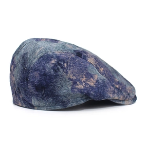 Detailed side view of vintage marble pattern newsboy cap with neat stitching and blue-grey tones