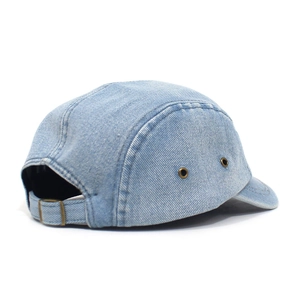 Detail of light blue denim 5-panel hat showing adjustable metal buckle and breathable eyelets