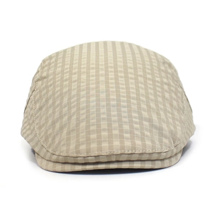 Detailed close-up of beige plaid flat cap featuring quick-dry fabric and adjustable strap