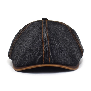 Detail of washed black denim octagonal hat with contrast stitching and leather trim