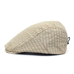 Detail of adjustable drawstring buckle on light khaki plaid summer flat cap