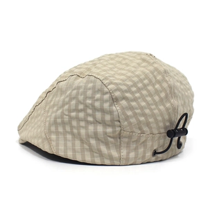 Detail view of khaki plaid flat cap featuring an adjustable elastic drawstring cord