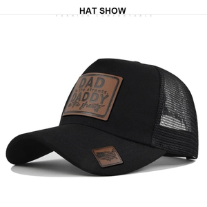 Close-up of black mesh trucker hat featuring a brown leather patch and USA map detail