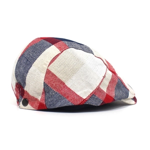 Close-up of red, white and blue plaid fabric texture with round black metal side buckle