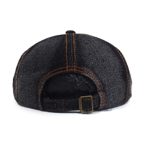Detail of washed denim octagonal hat with yellow contrast stitching and metal buckle