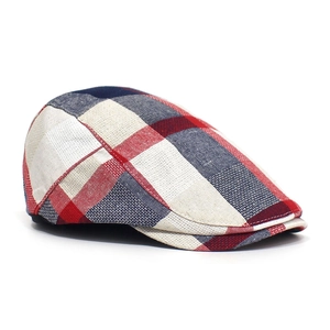 Detailed close-up of red and blue checkered plaid fabric on the classic flat cap