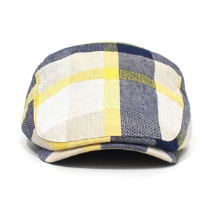 Detail of yellow blue plaid pattern and cotton linen texture on retro flat beret cap