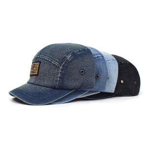 Five-panel denim baseball caps in four washed colors with a vintage metal logo patch