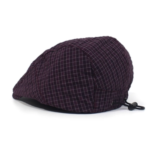 Detail view of purple checkered beret hat featuring an adjustable elastic cord and toggle