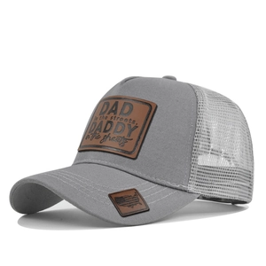 Close-up of gray mesh trucker hat with leather patch and USA map embroidery