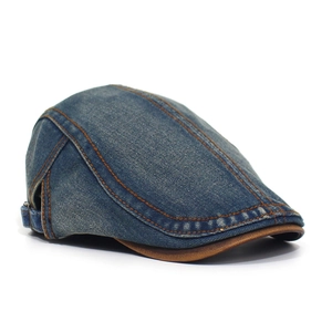 Detail of vintage denim beret featuring contrast stitching and adjustable metal buckle