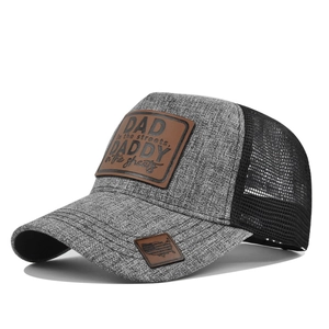 Detail of grey mesh trucker hat with brown leather patch and embossed DAD text