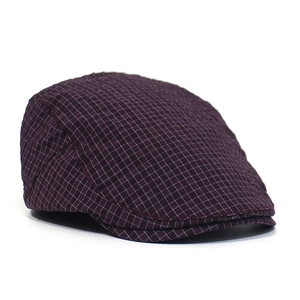 Close-up of the vintage purple plaid fabric texture and stitching on the flat cap