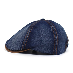 Detail of washed denim octagonal cap with brown leather piping and yellow contrast stitching