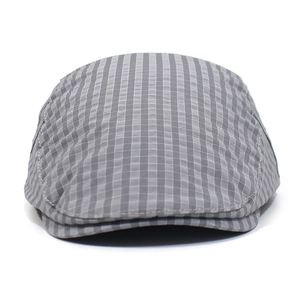 Detailed macro view of the grey and white plaid fabric texture on a flat ivy cap