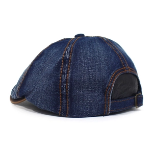 Detail view of washed denim octagonal hat featuring contrast stitching and adjustable metal buckle