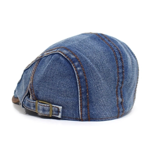 Detail of blue washed denim flat cap with adjustable metal buckle and contrast stitching