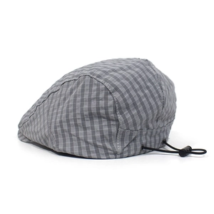 Detail of adjustable elastic drawstring and grey plaid fabric on the quick-dry flat cap
