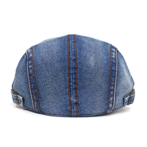 Detail of blue denim ivy cap back featuring adjustable metal buckles and brown stitching