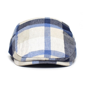 Close-up of blue and beige plaid pattern on textured fabric of the newsboy cap
